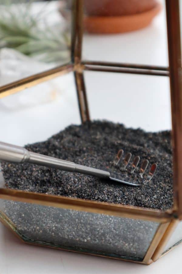 black sand layer in a geometric terrarium