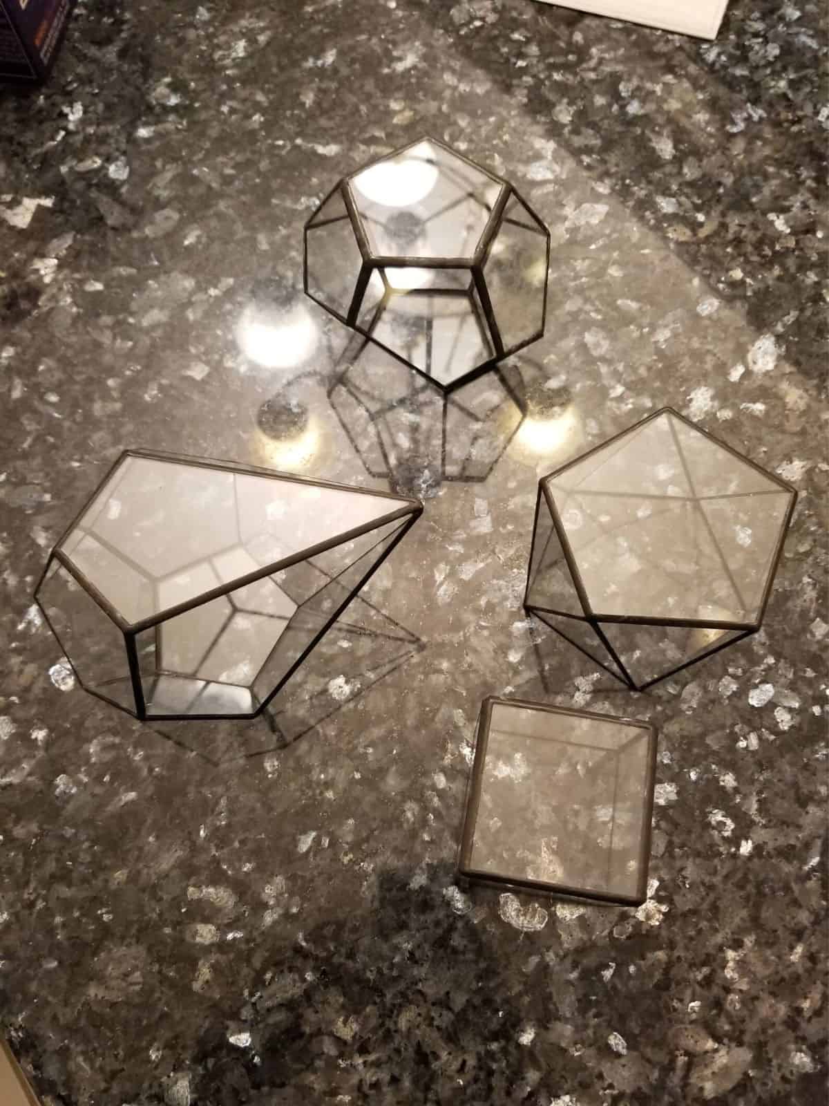 Group of differently shaped glass geometric terrariums 