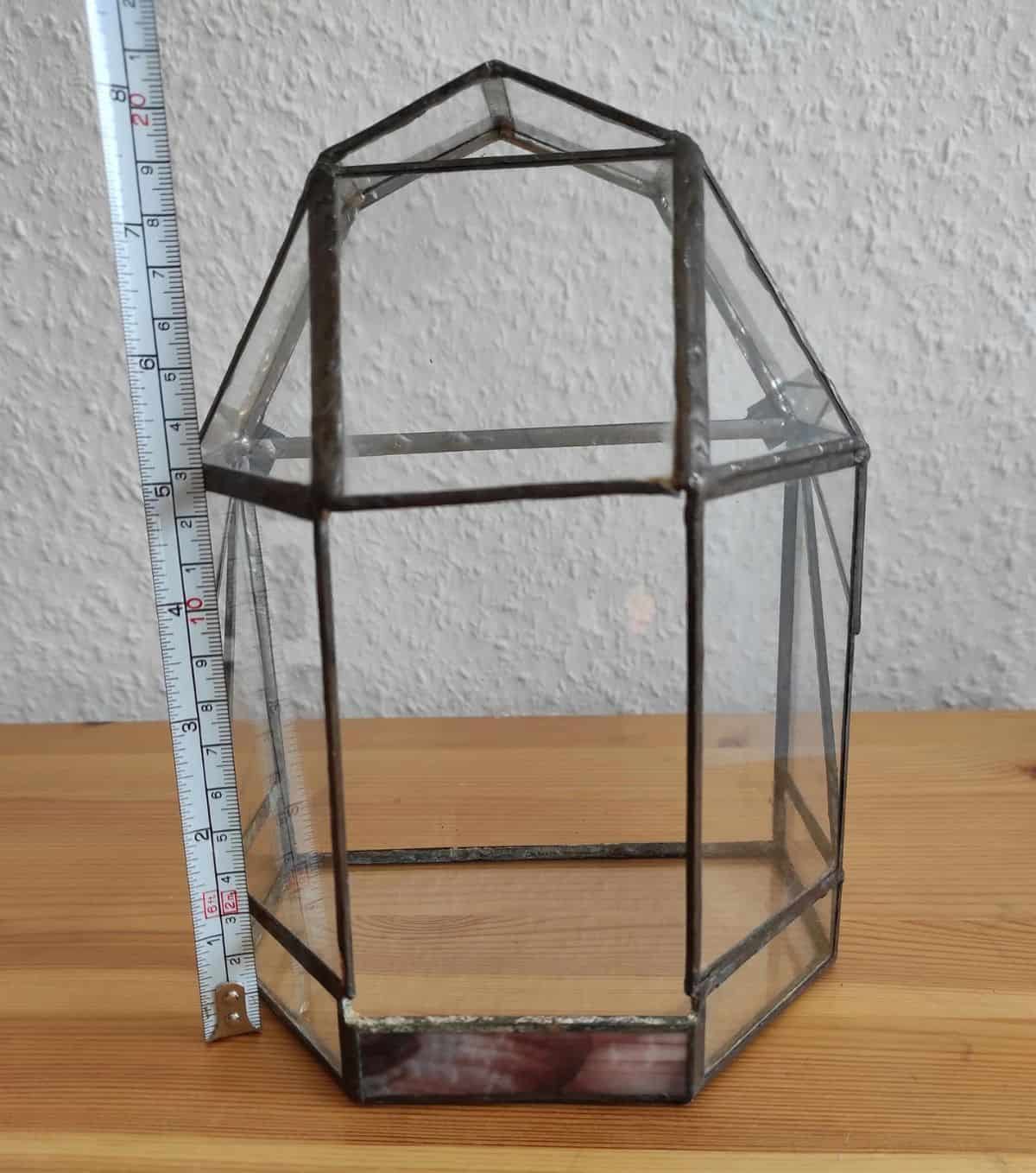 Vintage geometric terrarium next to a tape measure showing around 8 inches in height